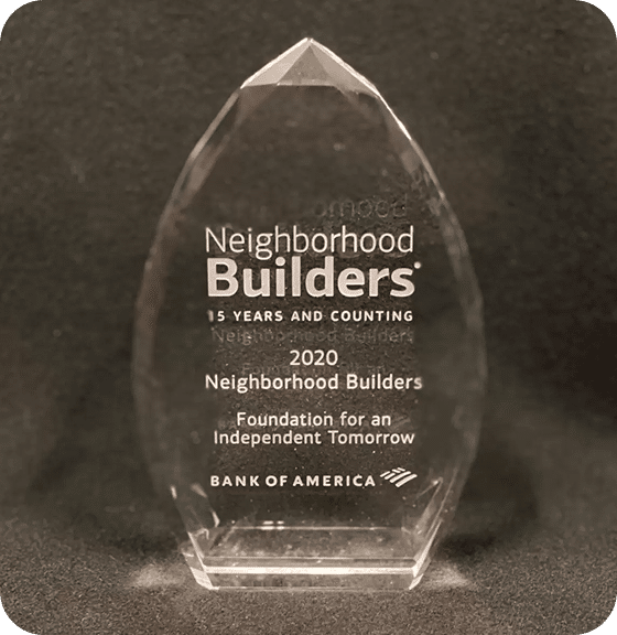 A clear crystal award reads "Neighborhood Builders," "15 YEARS AND COUNTING," "2020," and "BANK OF AMERICA."